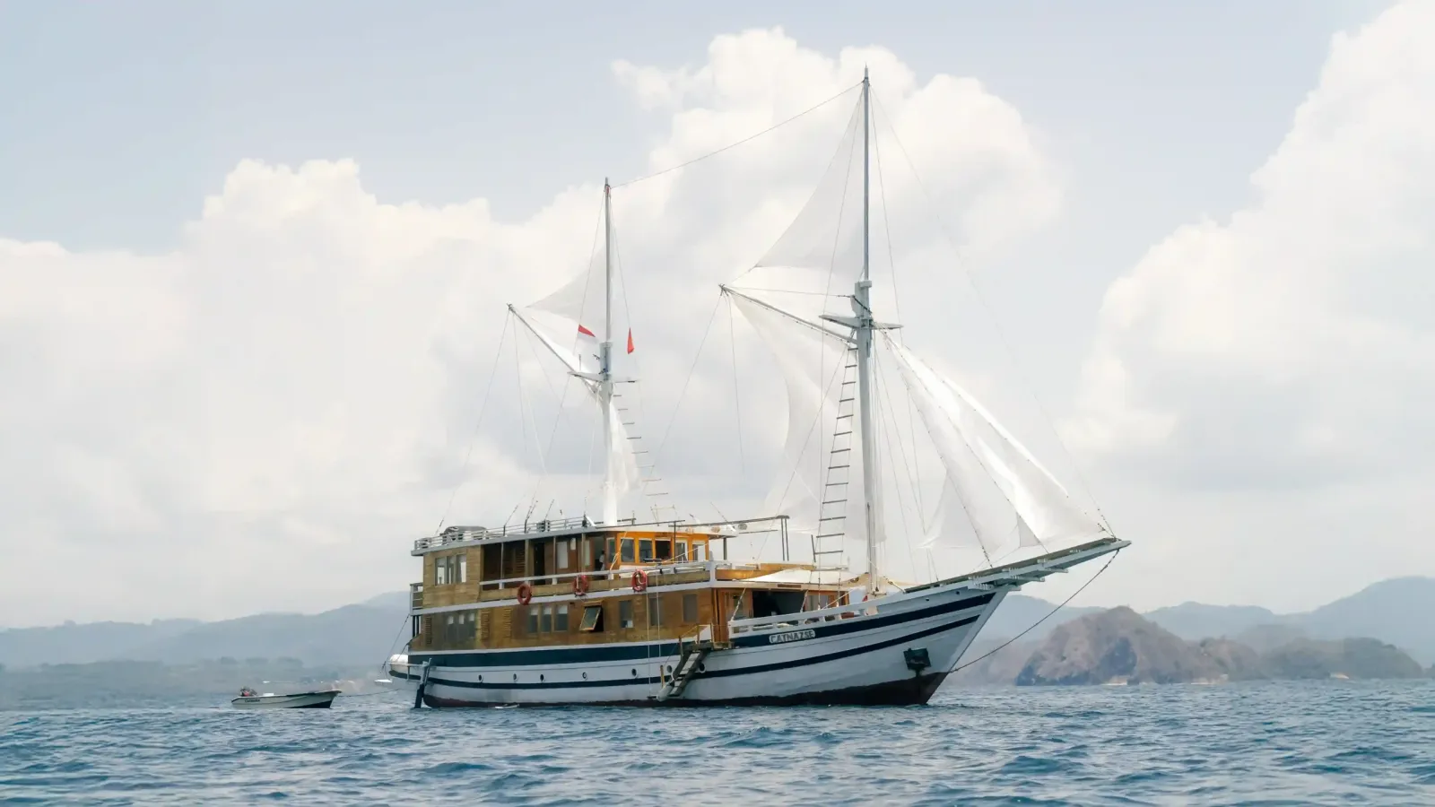 Phinisi under full sail in open water off Komodo